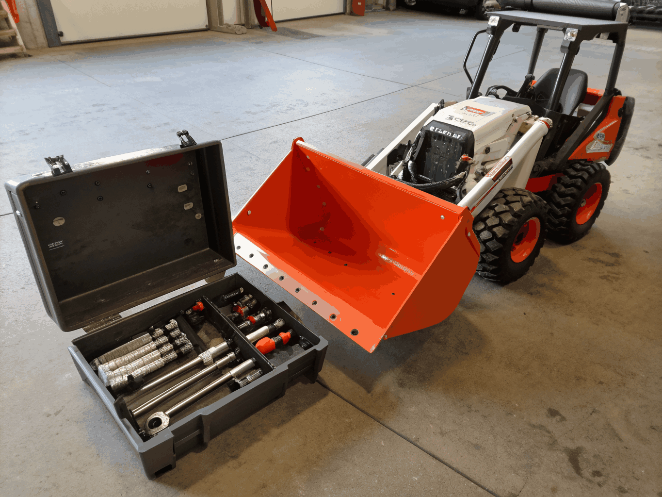 White Bobcat S76 skid steer loader on industrial site