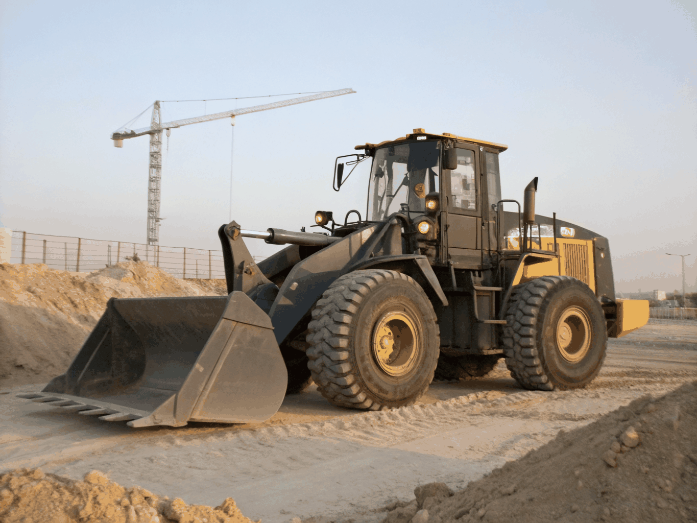 Tan Case compact wheel loader bucket down